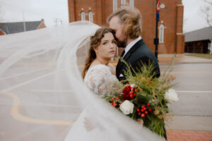 Couple standing in front of there wedding venue Abbey on Main 