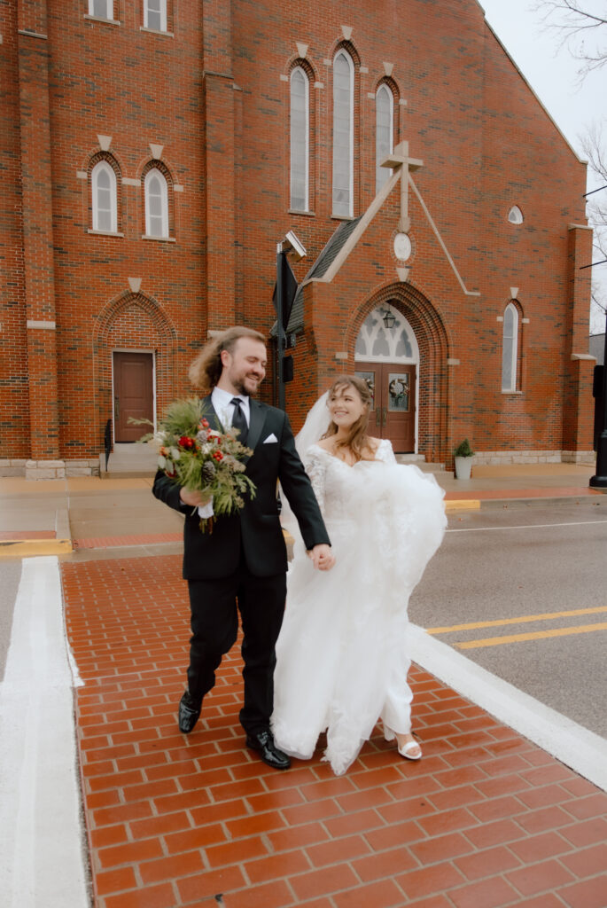 Couple walking in-front of there wedding venue.