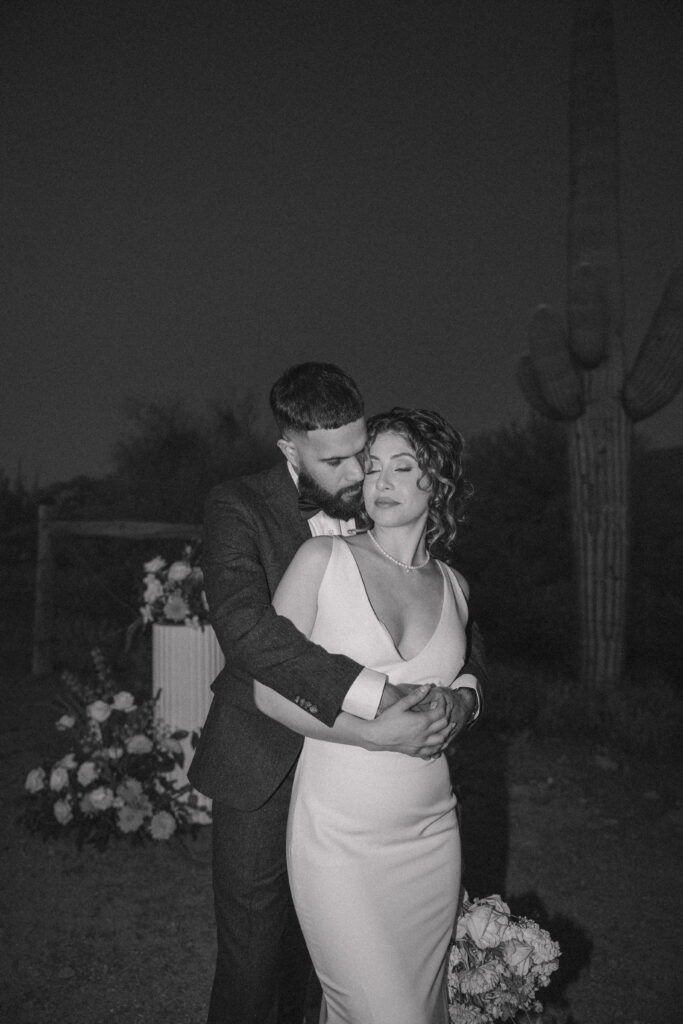 the groom standing behind the bride 