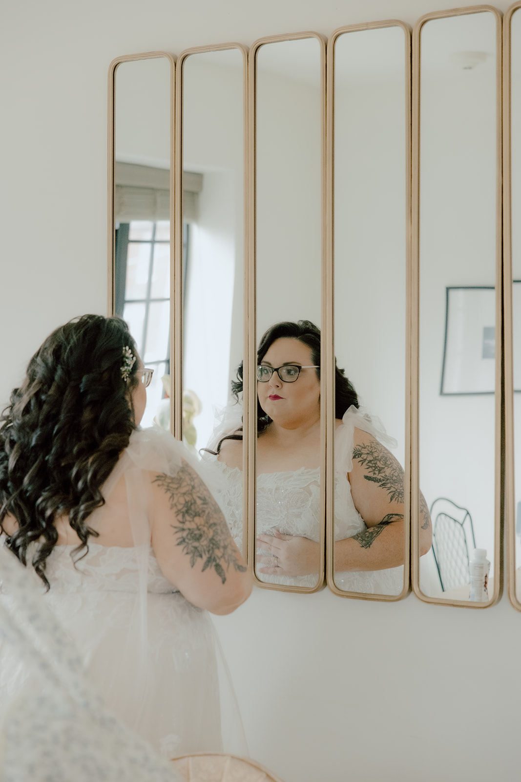 bride looking in the mirror at the wild carrot wedding venue 