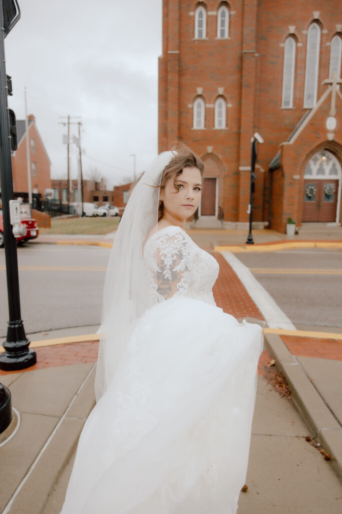 Bride shot of her walking down a street.